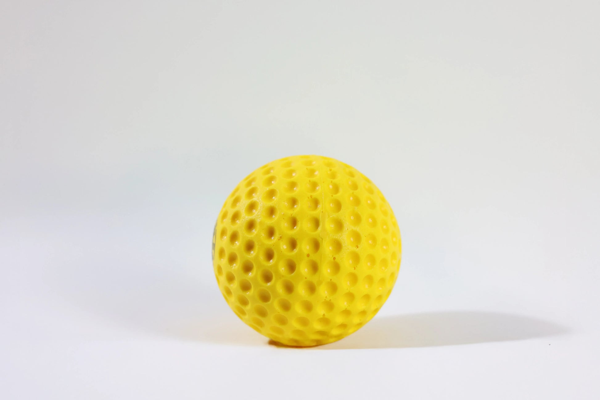 Yellow Crikon Dimple Cricket Ball with aerodynamic dimple design for swing and pace practice